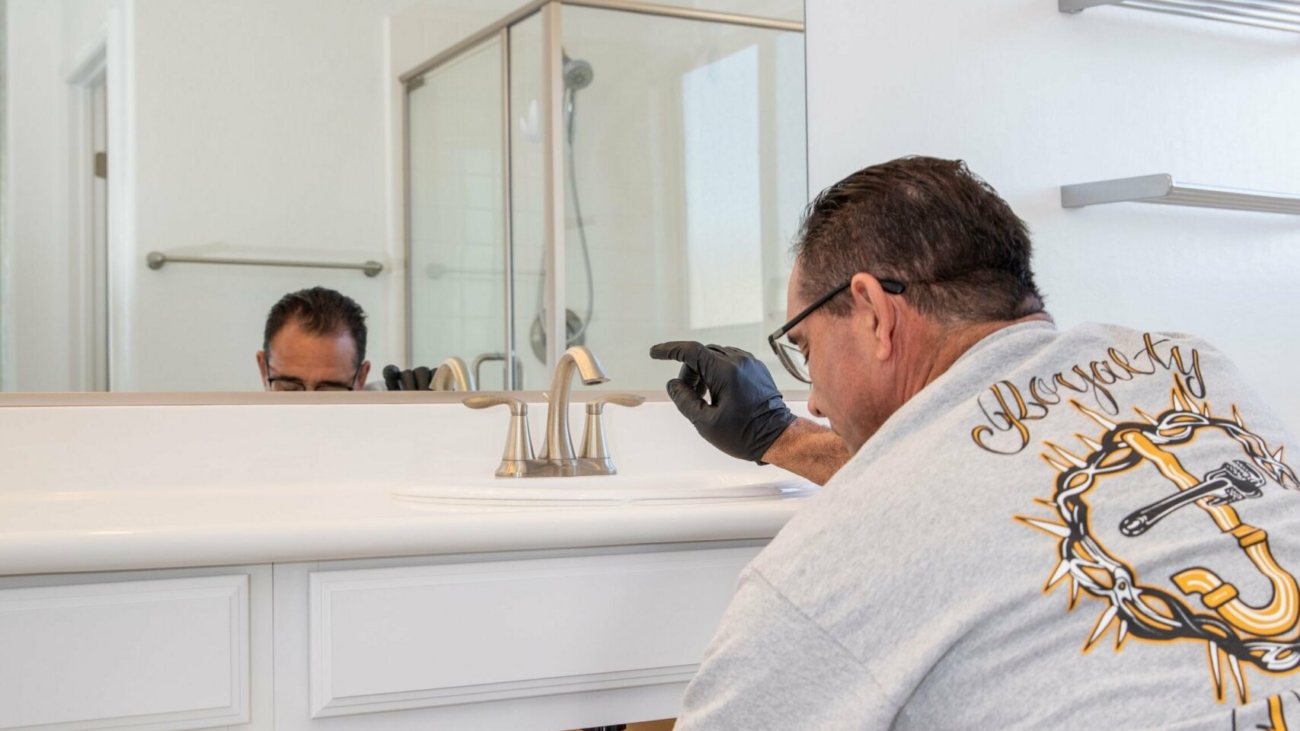 Royalty Plumbing plumber working on a sink