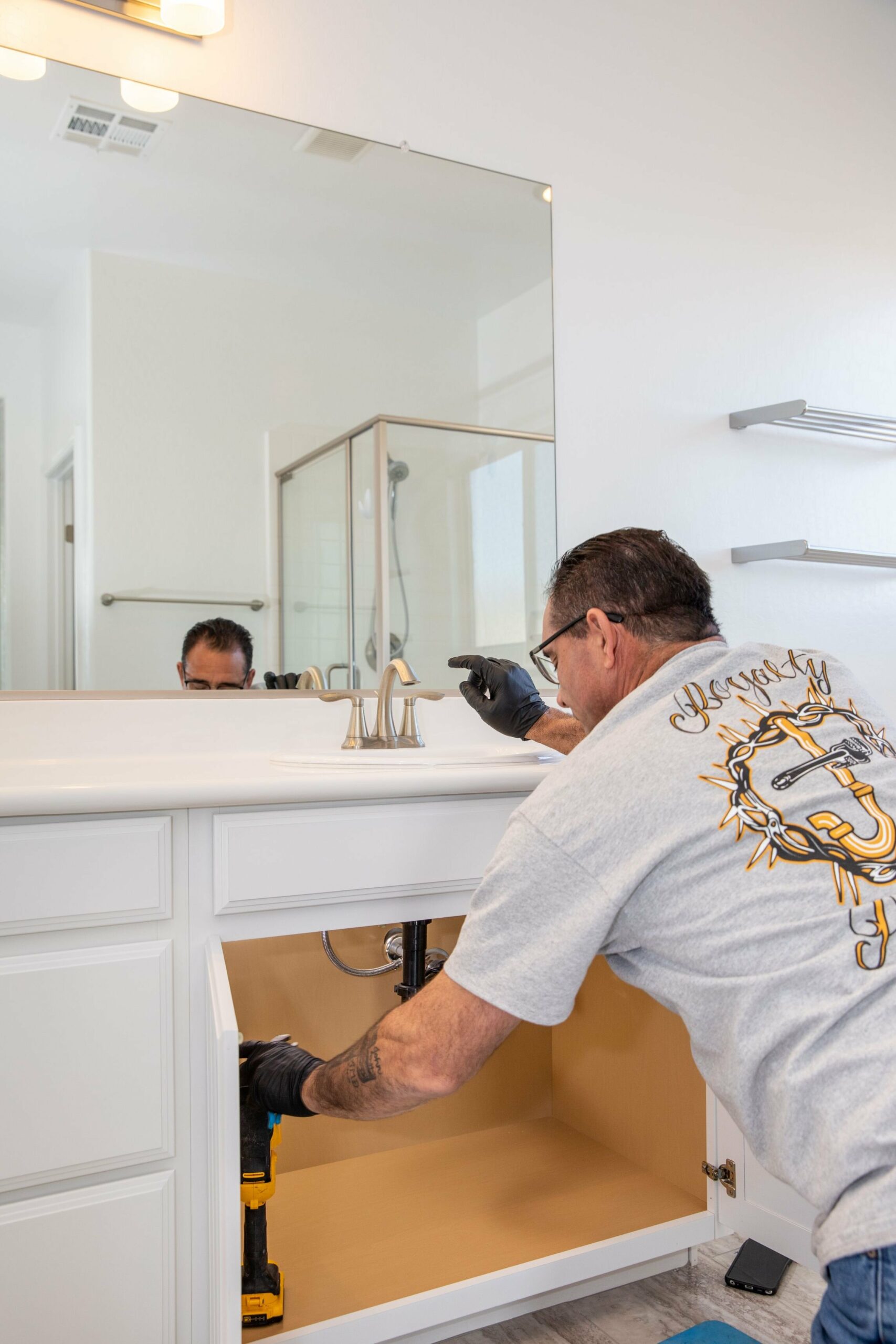 Royalty Plumbing plumber working on a sink