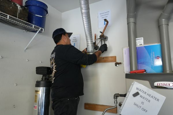 Tank water heater installation in progress