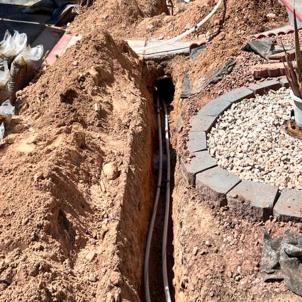 Professional plumber excavating a front yard