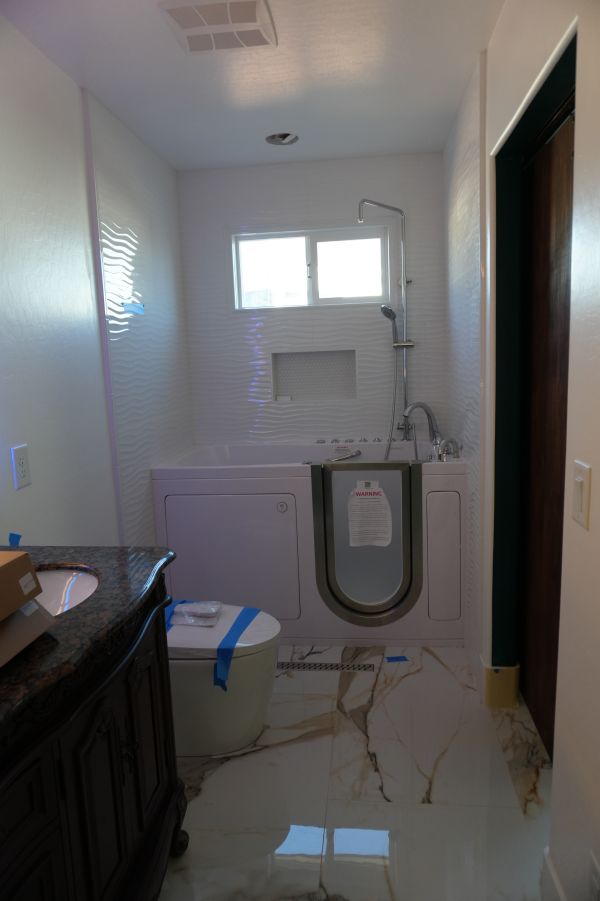 Licensed plumber installing pressure-balancing shower valve rough-in in Las Vegas bathroom wall