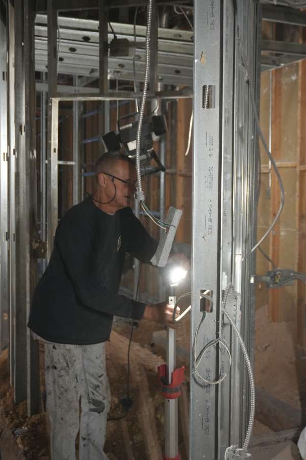 Royalty Plumbing plumber inspecting under-sink drain components during Las Vegas sink repair