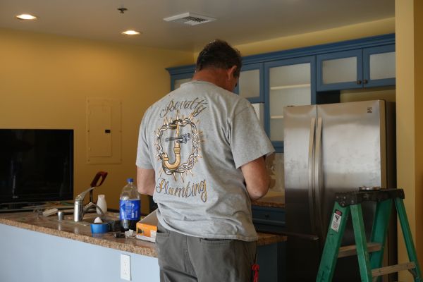 A professional plumber from Royalty Plumbing providing residential kitchen plumbing services.