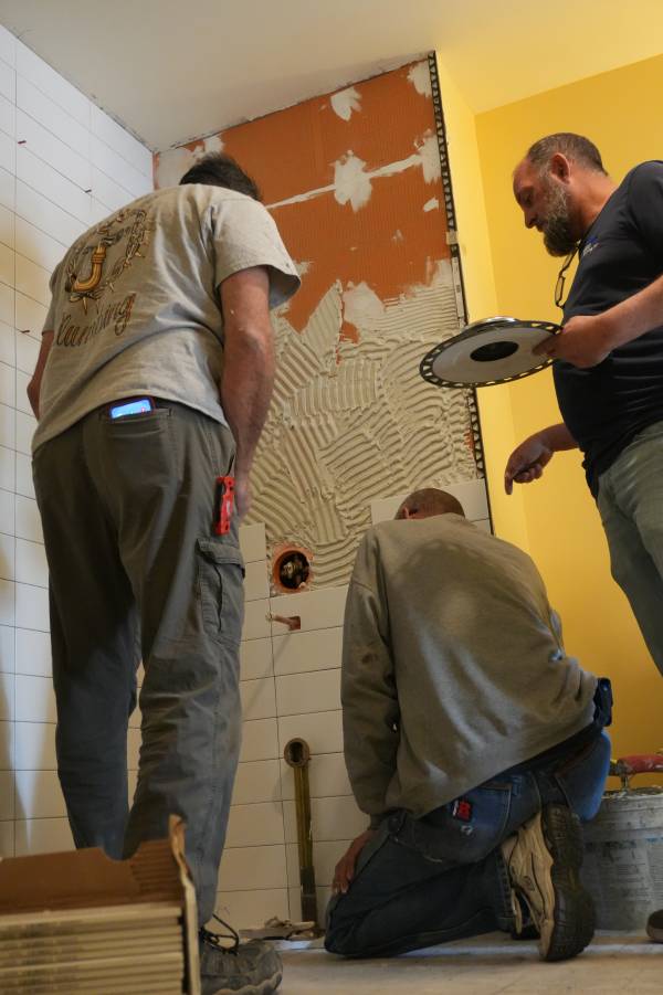 Licensed plumber installing pressure-balancing shower valve during Las Vegas bathroom remodel