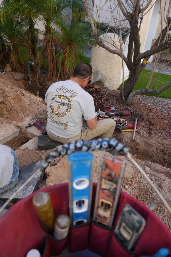 Royalty Plumbing plumber connecting drain assembly under new kitchen sink in Las Vegas