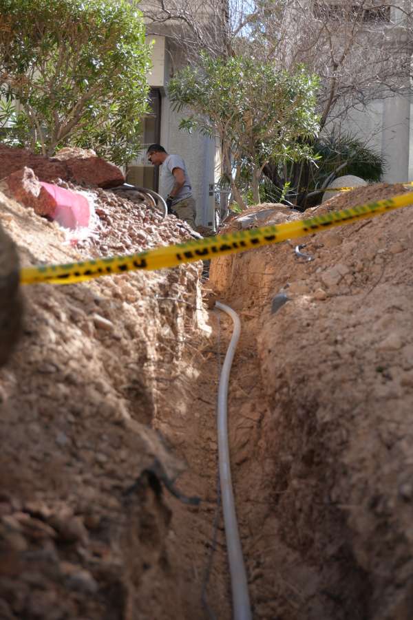 Royalty Plumbing service truck at water main line repair job in Las Vegas residential yard