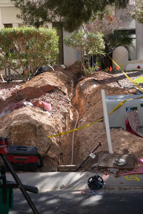 New PVC water service line being installed in Las Vegas residential yard trench