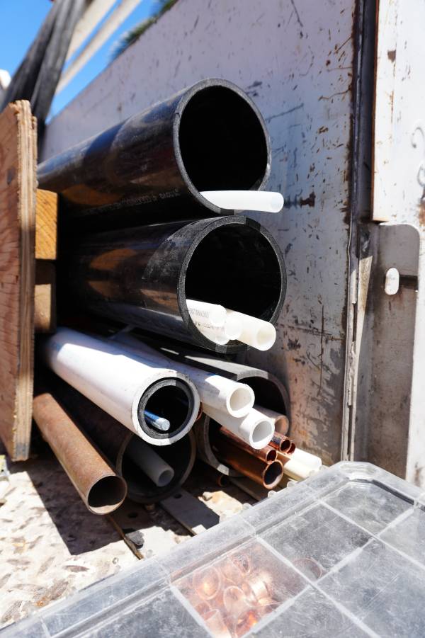 Royalty Plumbing plumber showing different sizes of InSinkErator garbage disposals for Las Vegas kitchen