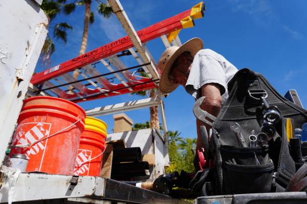 Licensed Las Vegas plumber installing new PVC sewer pipe in trench