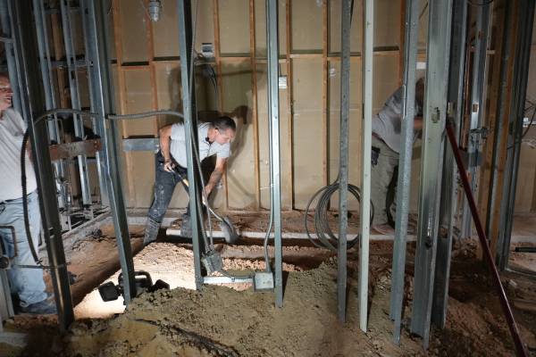 Royalty Plumbing plumber performing sewer line visual assessment at cleanout in Las Vegas yard